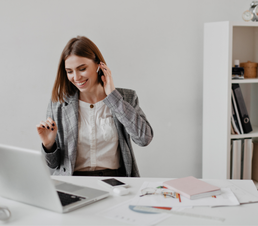 sweet-short-haired-business-lady-laughs-while-listening-music-headphones-portrait-woman-office-clothes-sitting-workplace 1